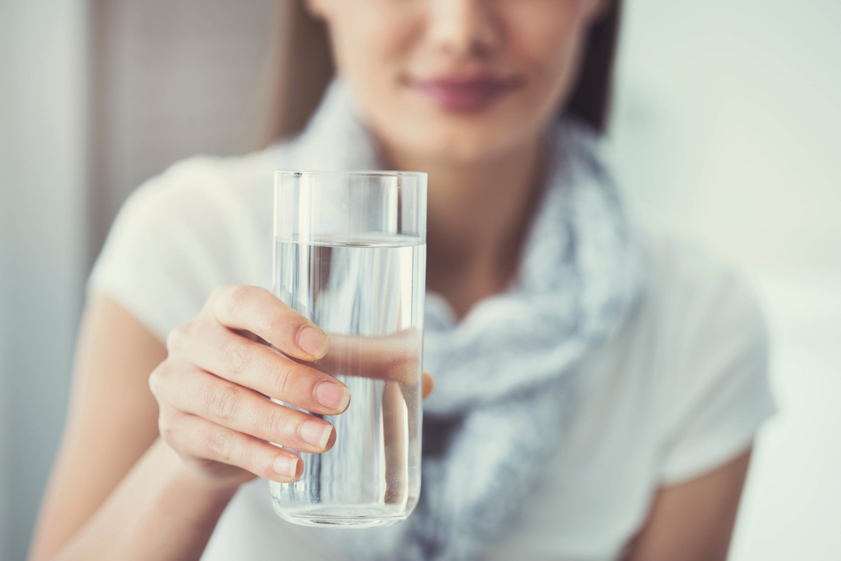 Woman handing over a glass of water