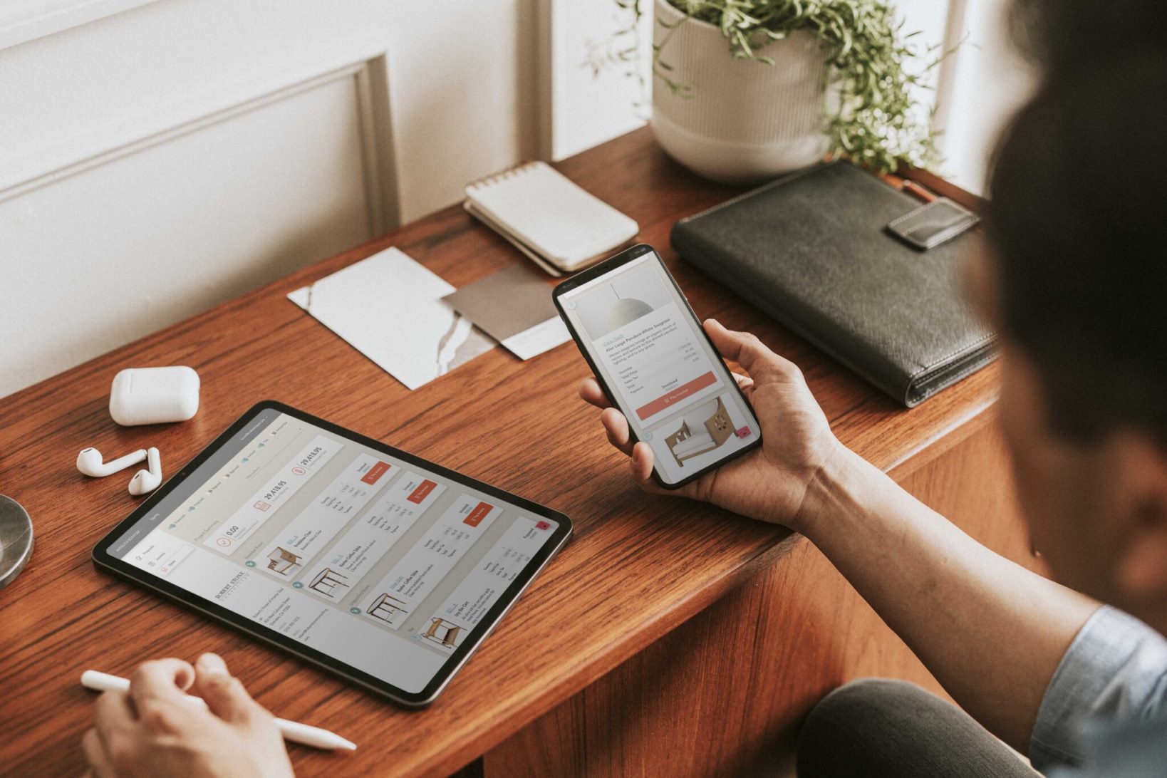 The man using the Studio Designer application on his tablet and phone