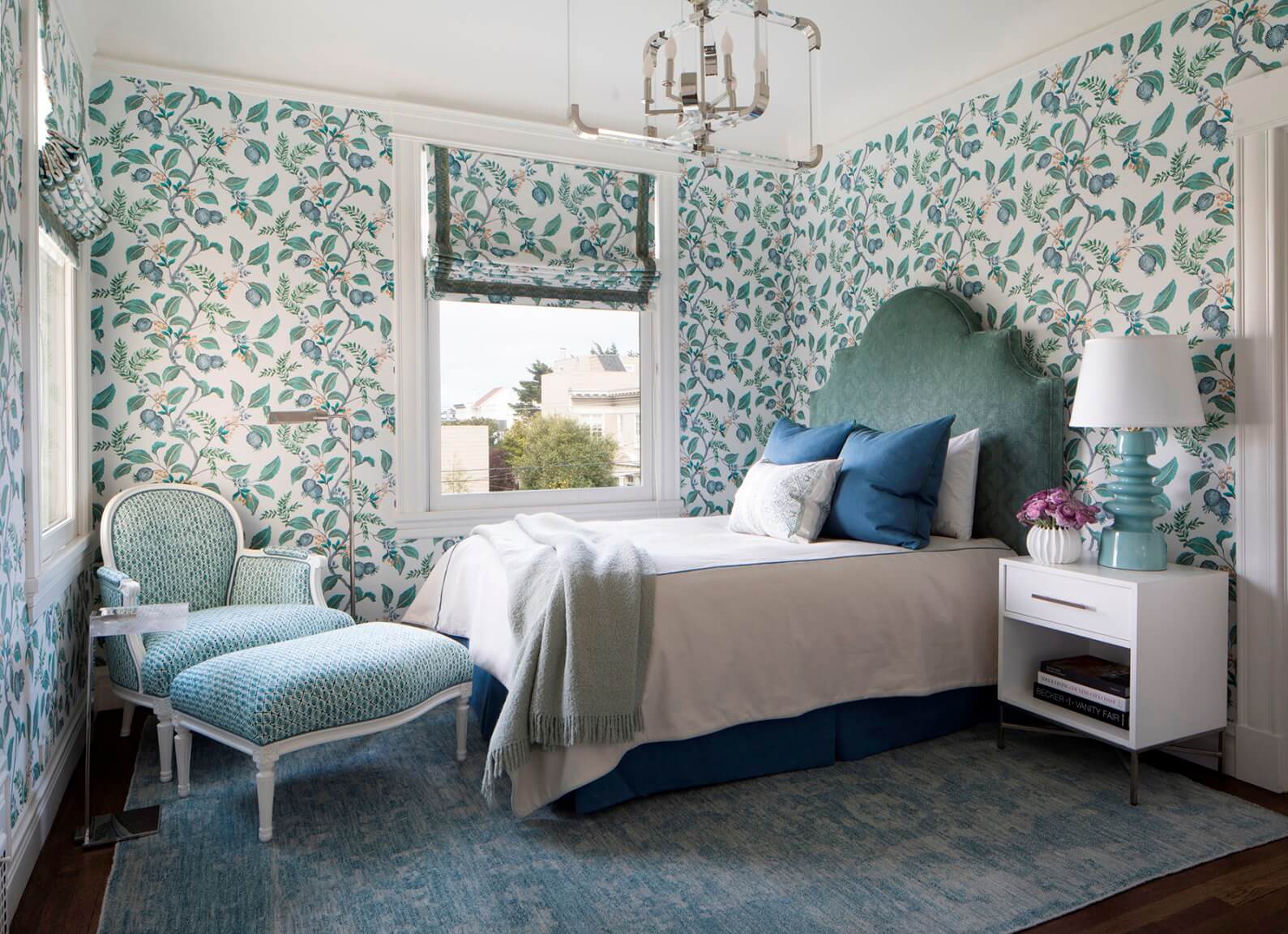 Bedroom with wallpaper featuring green leafy pattern