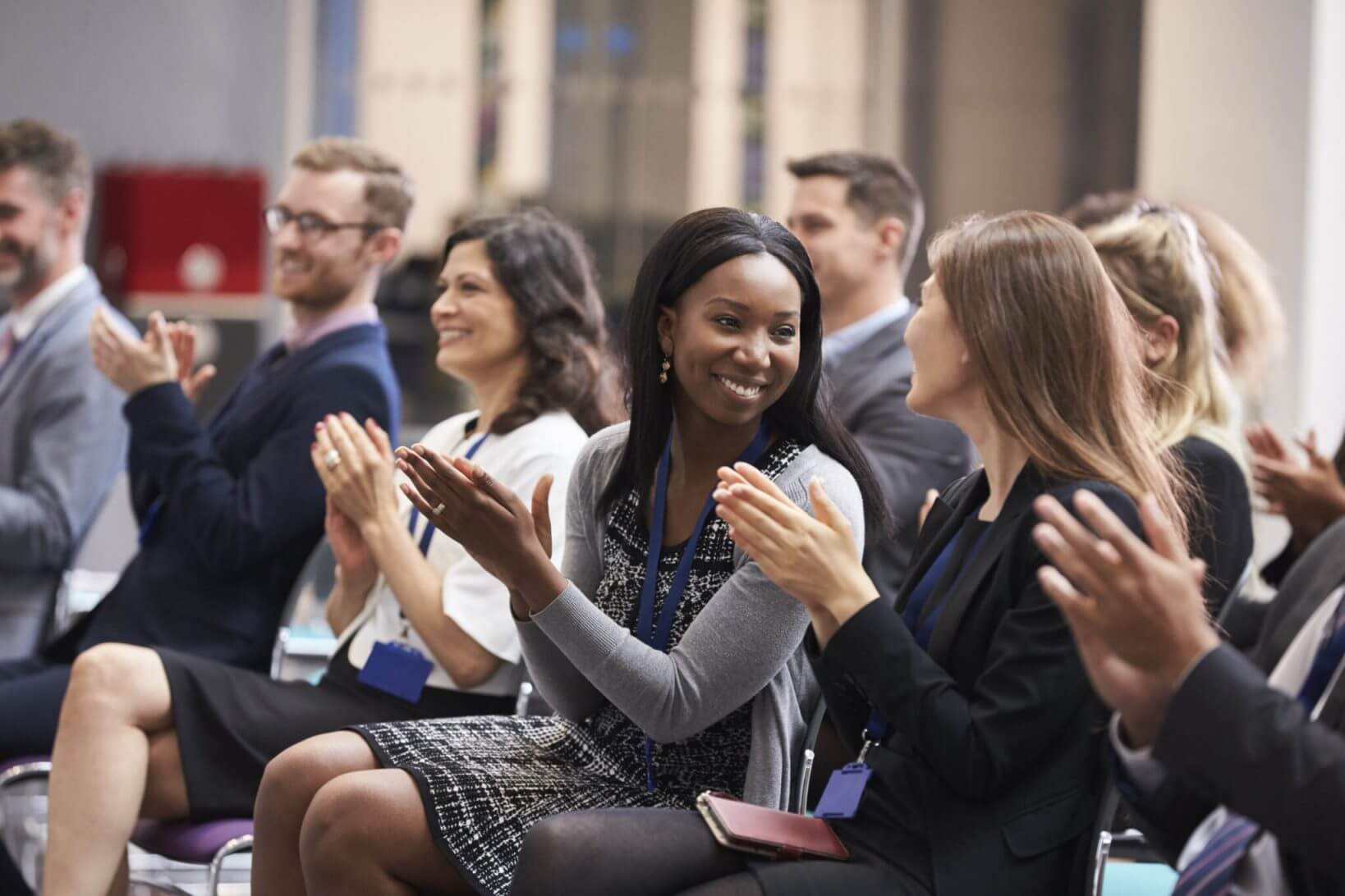 Group of people is clapping during the conference