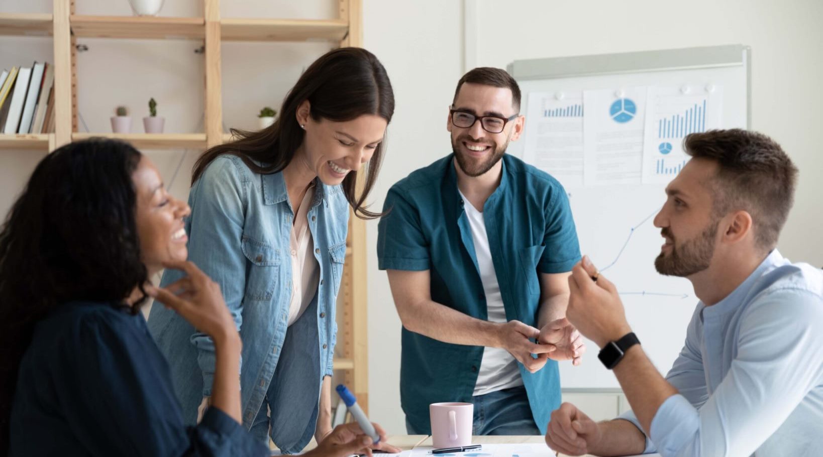 Four people working in the office room