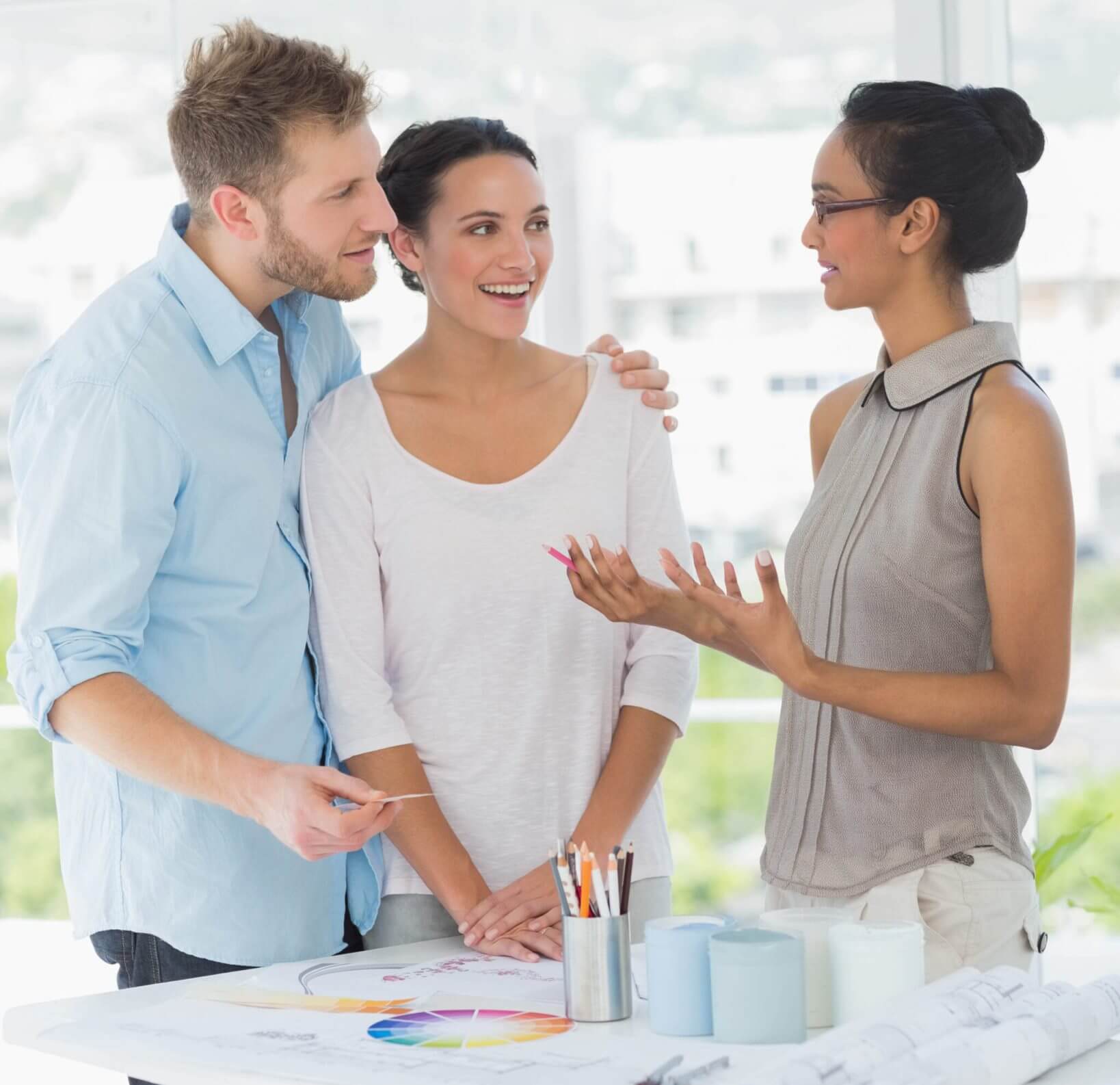 A couple with a designer looks at color palettes