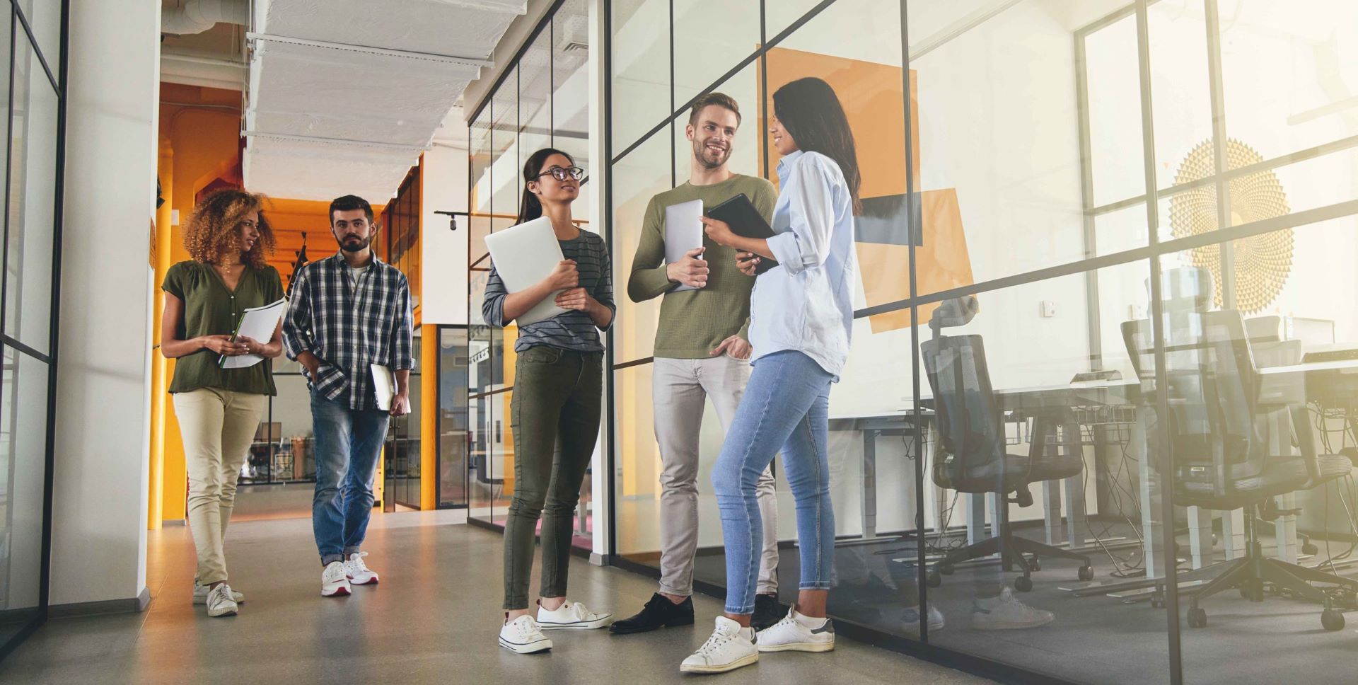 Employees talk to each other in the office corridor