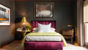 Dark bedroom with a burgundy bed