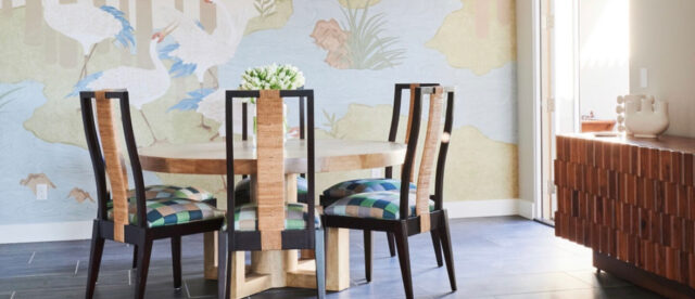 Table in the dining room with chairs with colorful upholstery