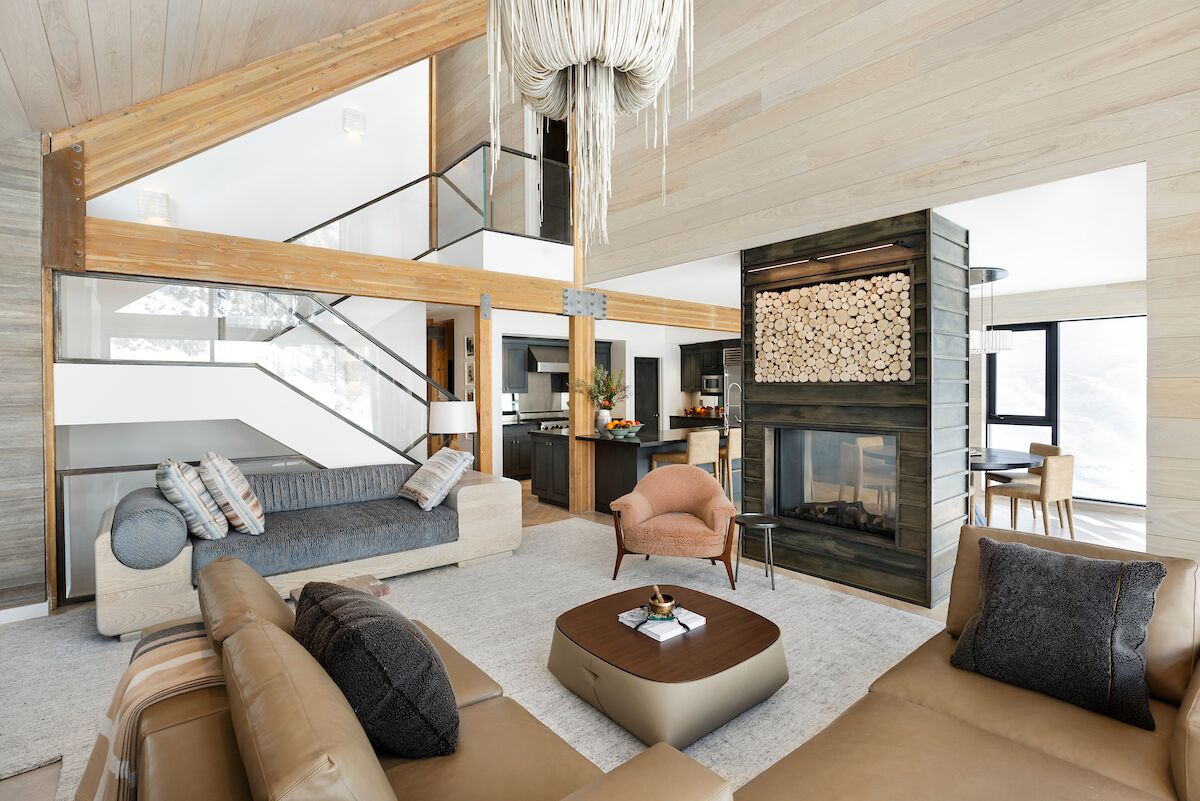 Bright and spacious interior of a house with fringe lamp and fireplace as bold accents