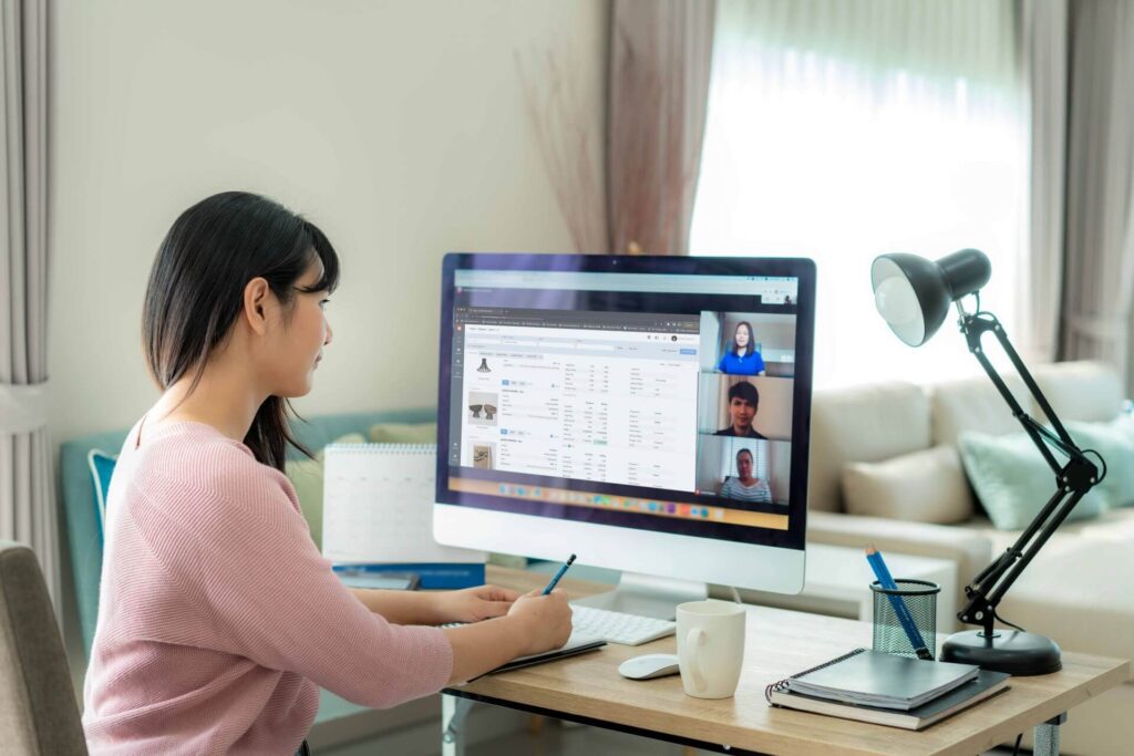 A woman connects via computer to a video call