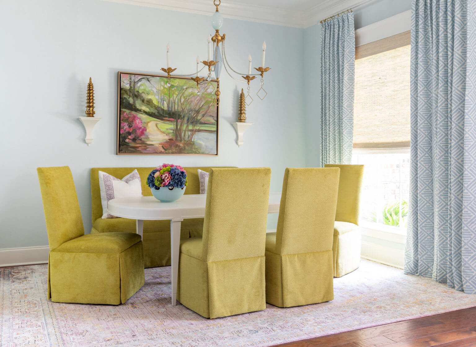 Table with yellow armchairs in a bright living room