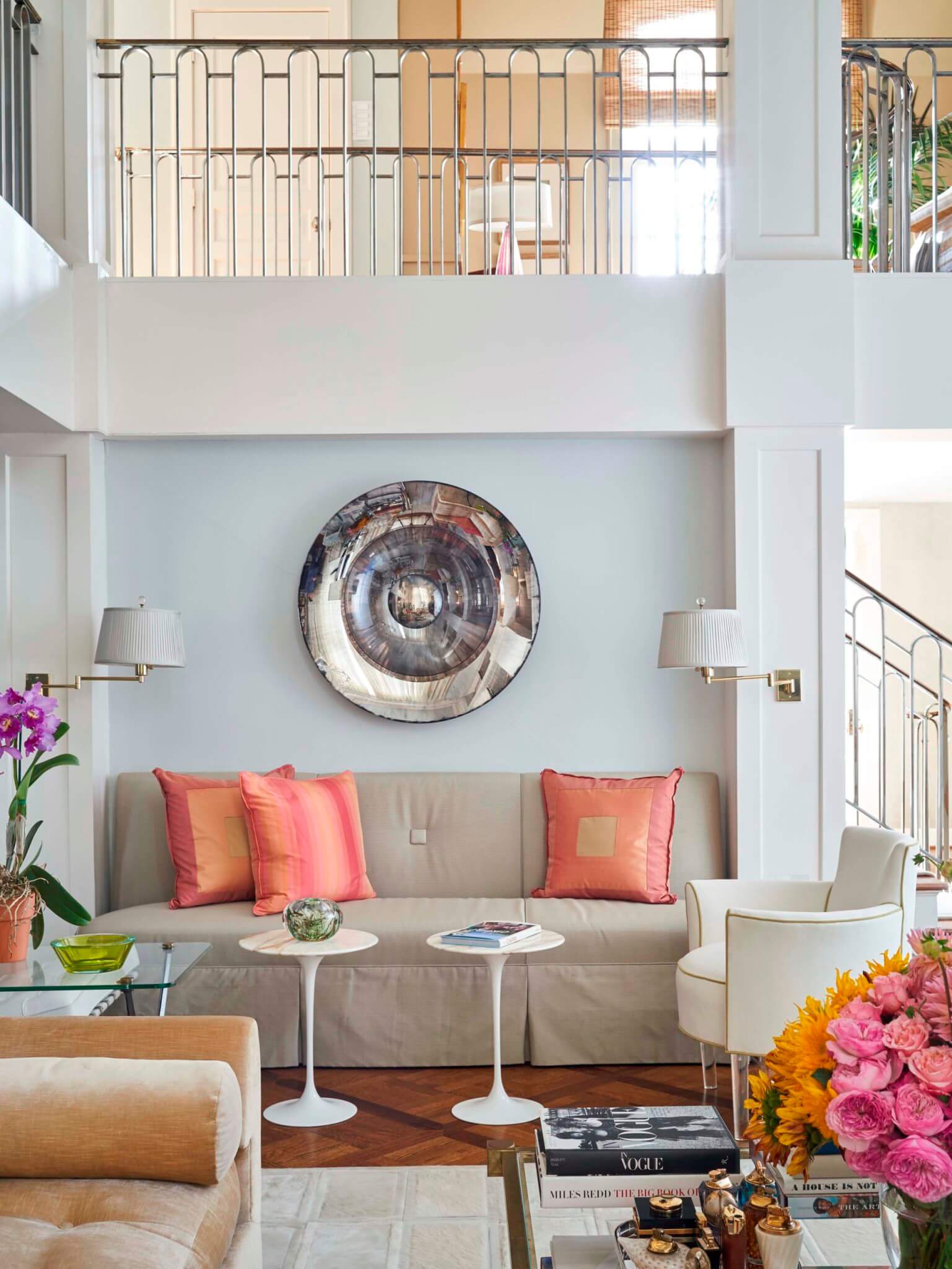 A small living room with a large mirror lamp