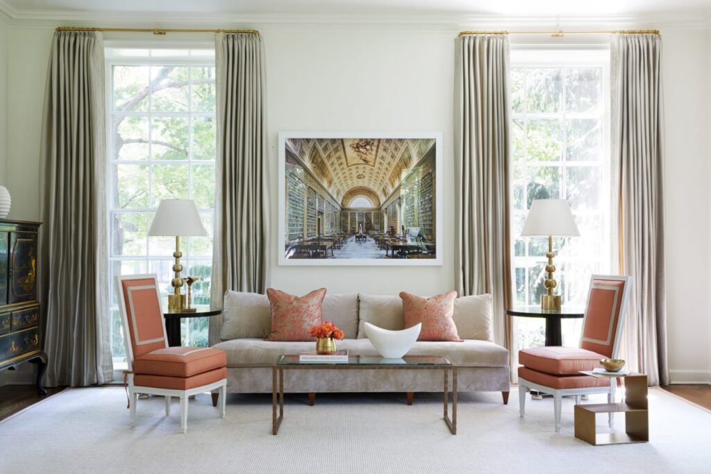 A small living room with two large windows