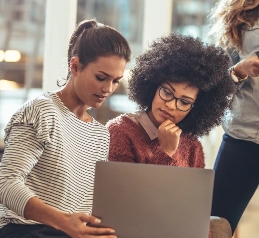 One person is showing the other the laptop screen