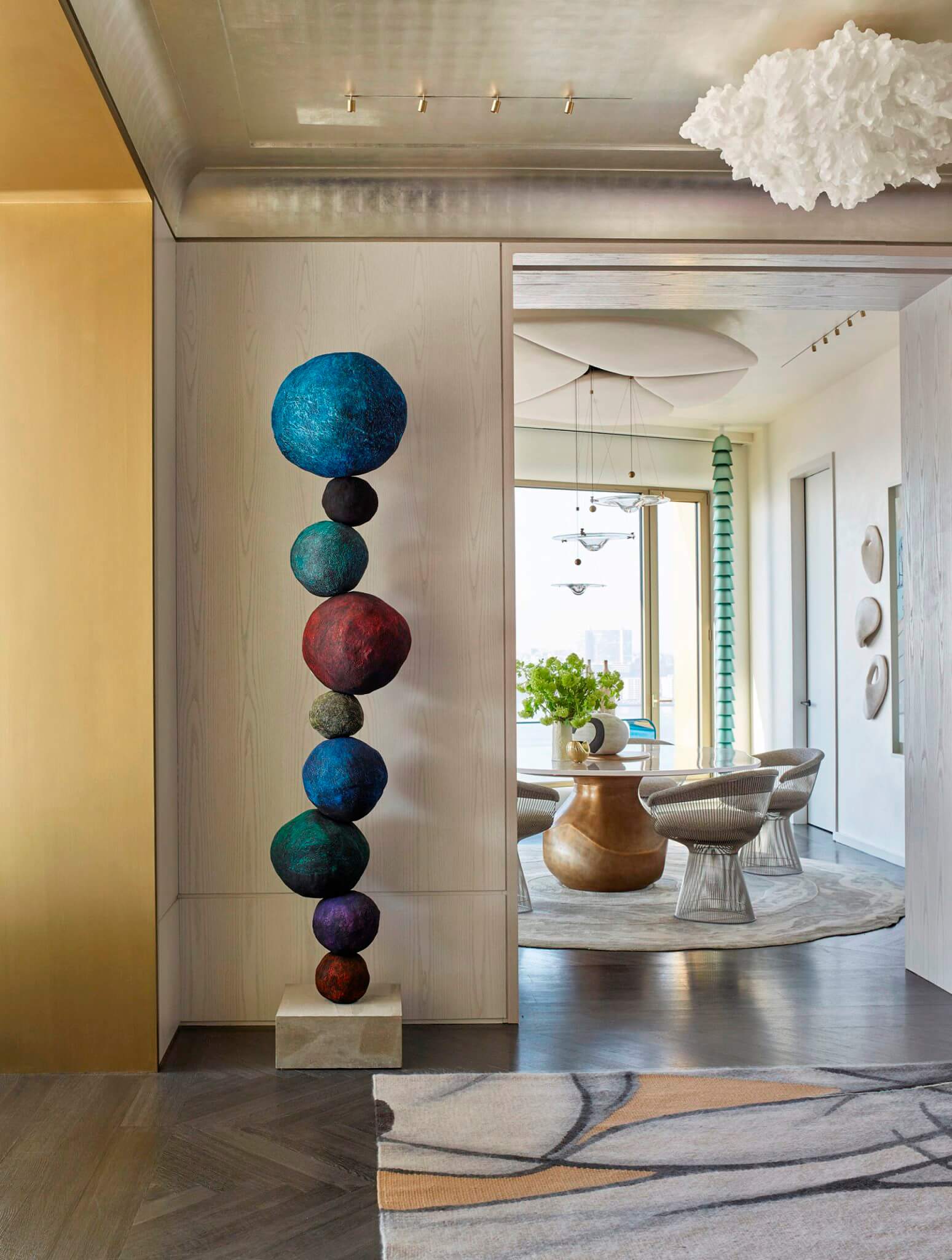 A sculpture consisting of colorful round stones standing in the hall