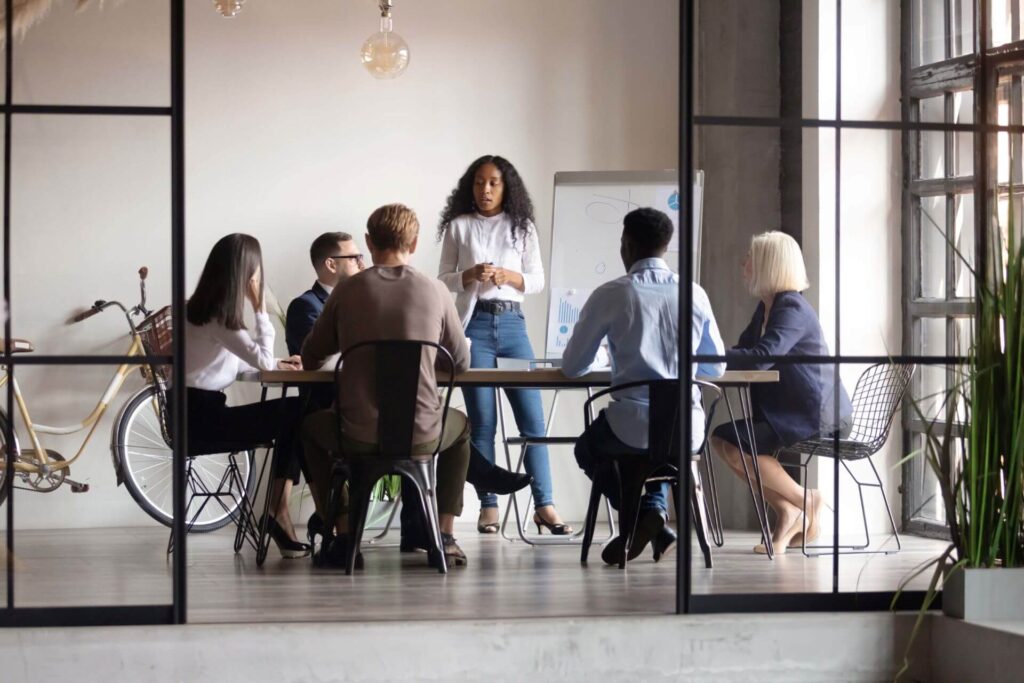 A group of people are discussing in a conference room