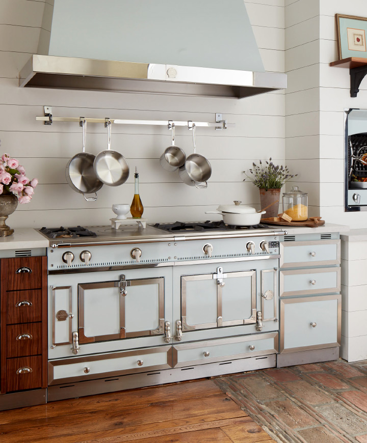 A large gas stove with a hood in a classic-style kitchen