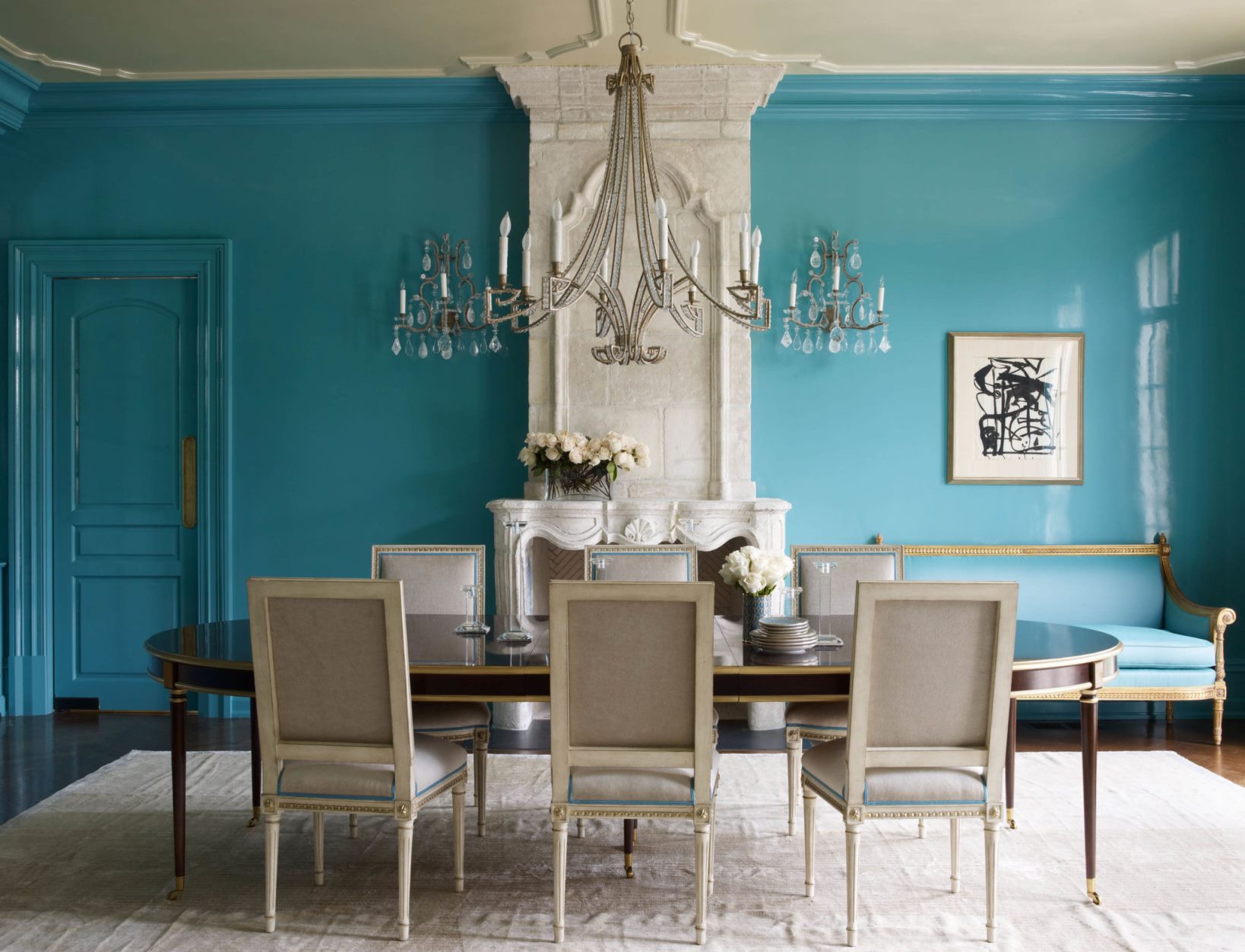 Dining room with a large table, fireplace and blue walls