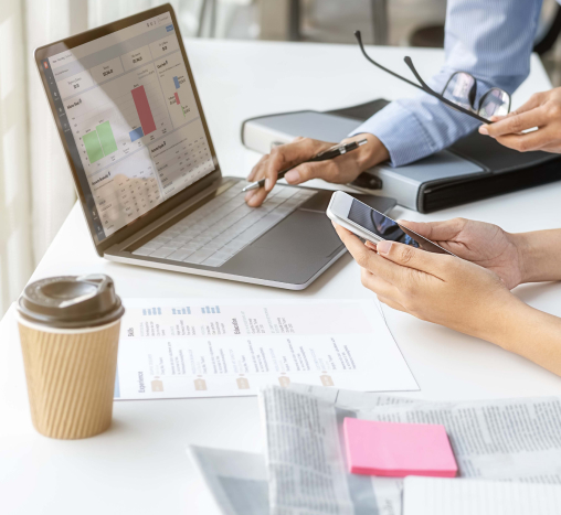 Two people checking the Studio Designer application on a laptop and a phone